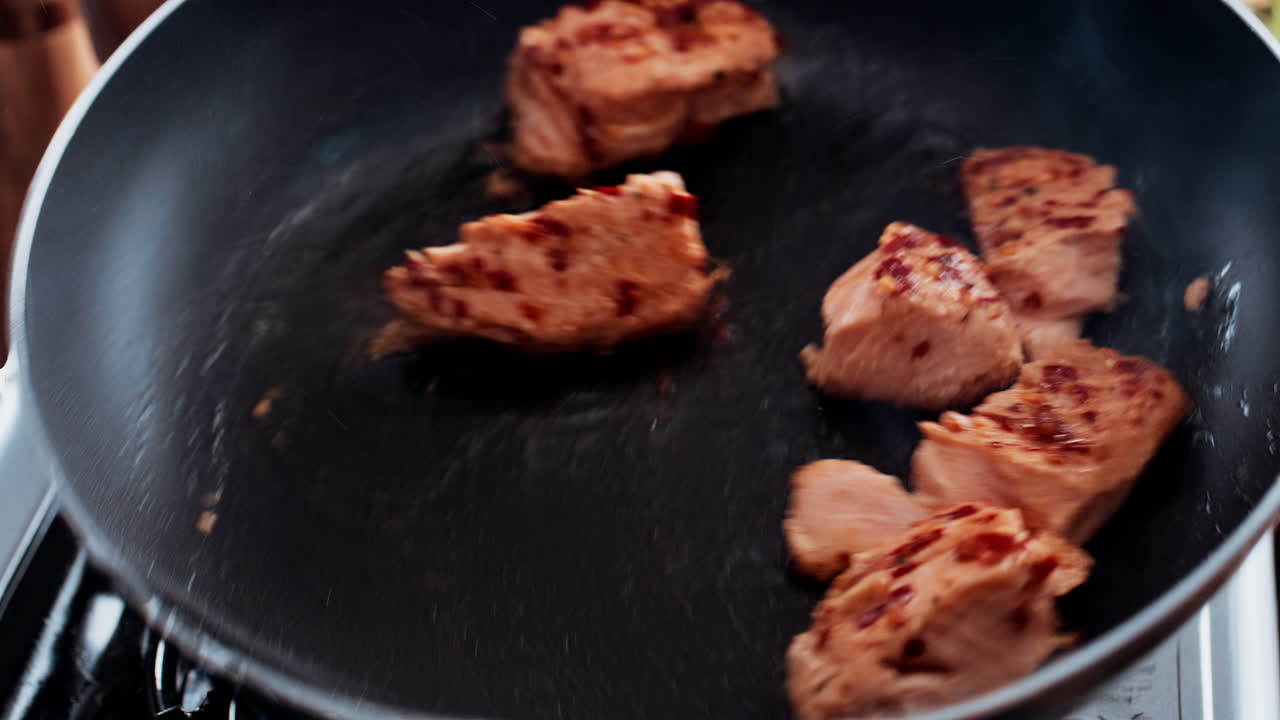 Salmon cooking in a pan