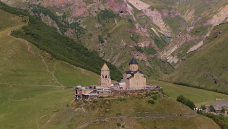 beautiful orbiting drone shot above famous gergeti trinity church in georgia