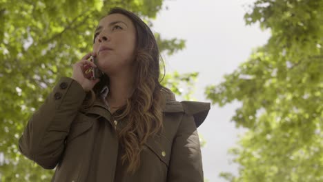 Bottom-view-of-young-woman-talking-on-smartphone.