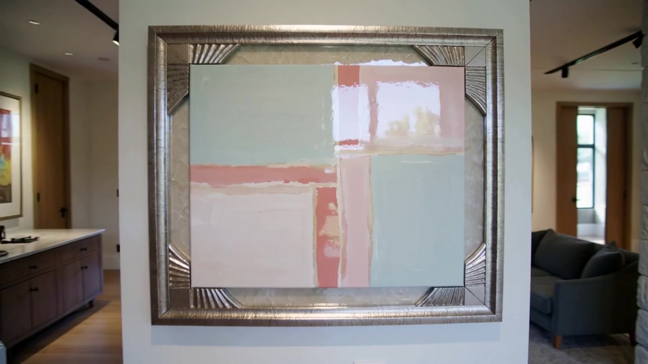 Starting left-angle move, camera panning through foyer to center ornate silver frame painting