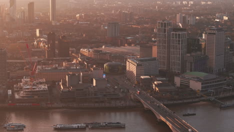 rising aerial shot of waterloo bridge and roundabout london at sunrise