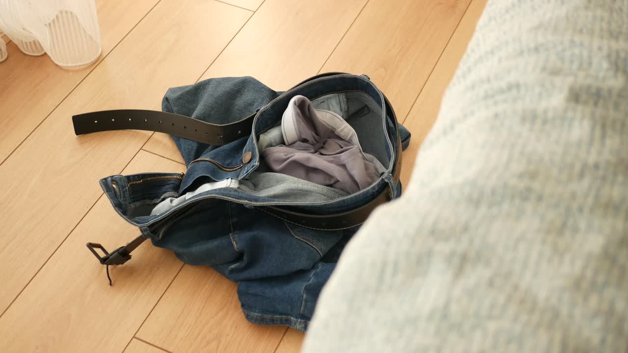 Jeans and Clothing on Wooden Floor