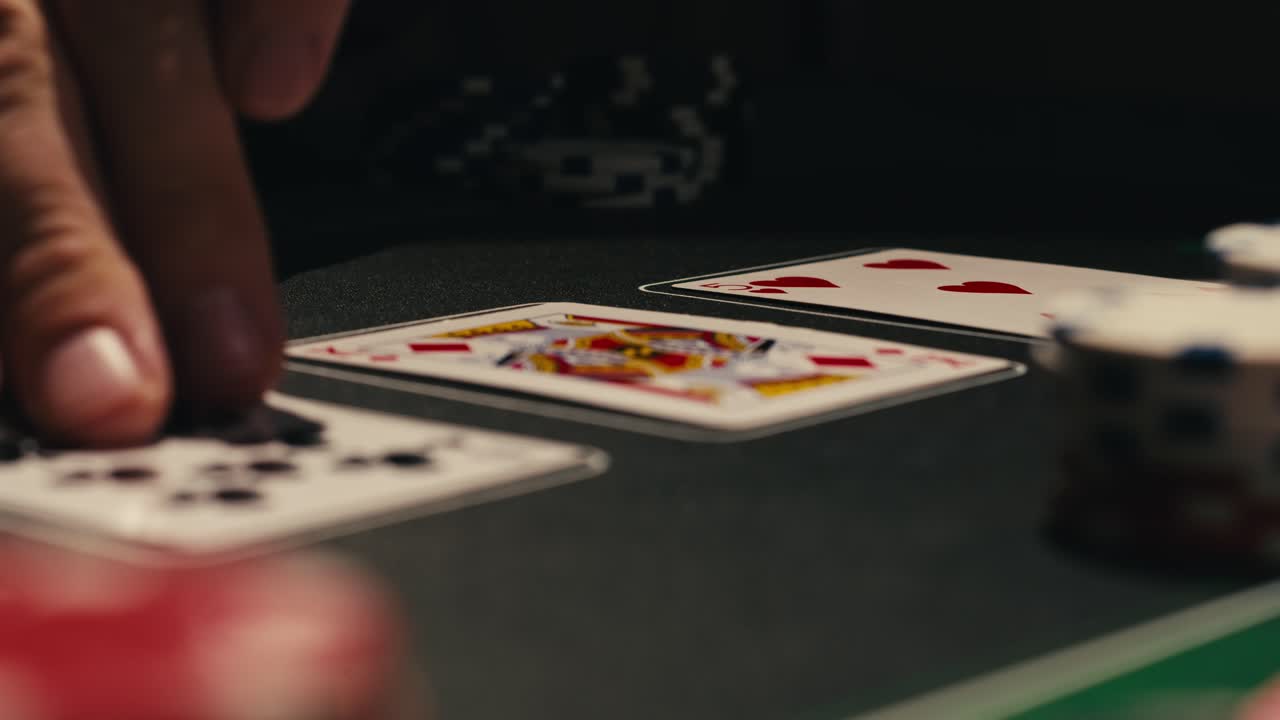 Hands managing poker chips on green table, reflecting intense poker gameplay with the element of chance and skill