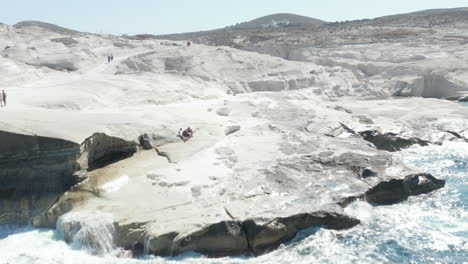 Aerial-Drone-Perspective-of--iconic-Lunar-Volcanic-white-chalk-beach-and-caves-of-Sarakiniko,-Milos-island,-Cyclades,-Greece