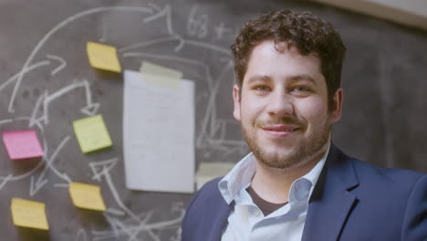 portrait shot of young successful businessman standing