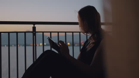 woman with tablet pc on the balcony overlooking sea