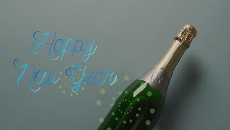 Animation-of-happy-new-year-text-over-champagne-bottle