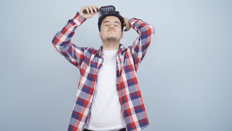 man combing his hair.