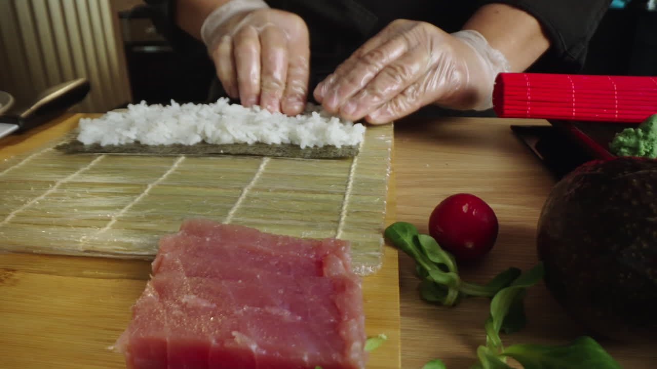 Preparing sushi rolls on a bamboo mat with fresh ingredients
