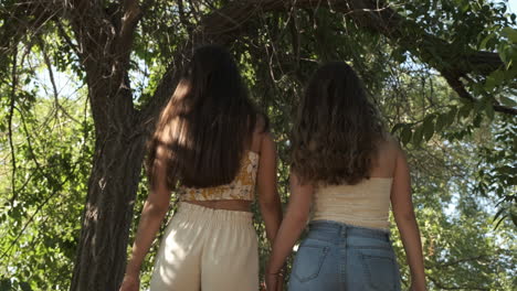 two young women walking together outdoors