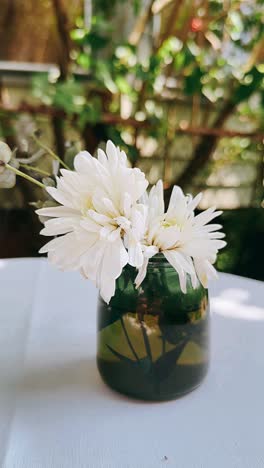 white chrysanthemum arrangement in a green vase