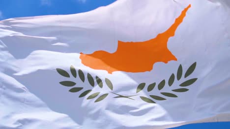 slow motion shot of cyprus flag fluttering in the wind with a bright blue sky backdrop