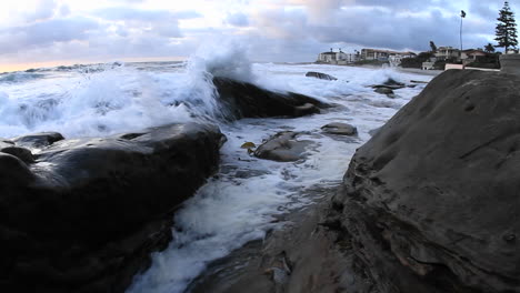 waves roll on to a beach just after sunset