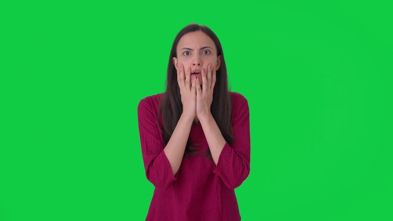 Indian woman getting a shocking news Green screen