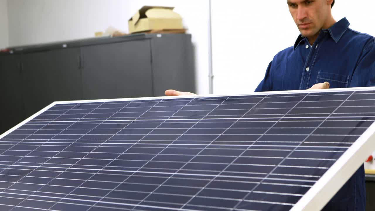 Male worker working on solar panel in office 4k