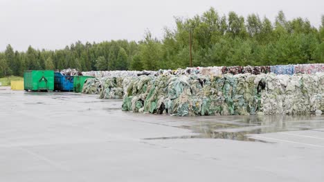 pilas de basura plástica compacta y otra basura almacenada para reciclar en vertederos cerca del bosque