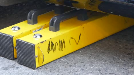 yellow parking block under a car