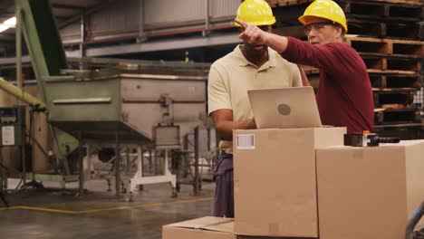 workers discussing over laptop