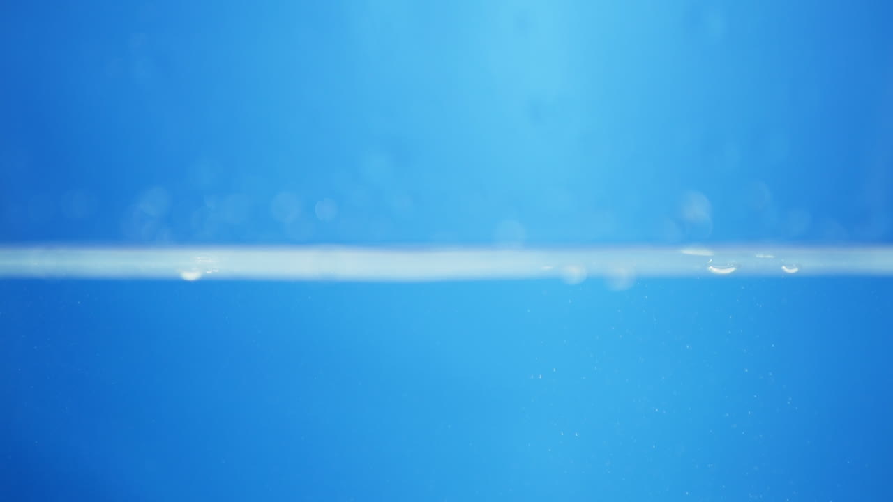 Water droplets scatter in mid-air, glistening with light and capturing the beauty of pure liquid in an energetic, creative splash.