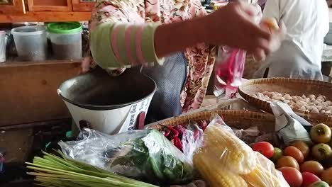 Asian-traditional-vegetable-market-Traders-wrap-chilies-tomatoes