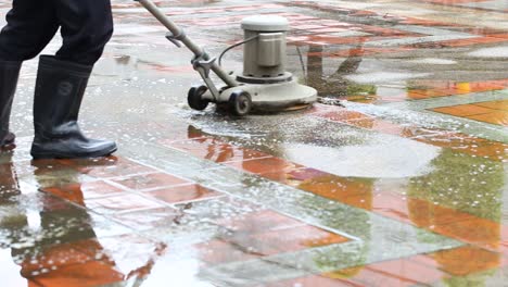 closeup shot of a man using industrial floor cleaning machine