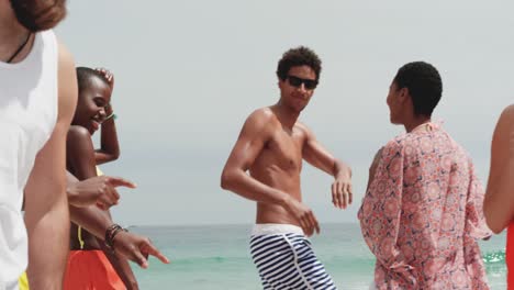 Group-of-mixed-race-friends-dancing-together-on-the-beach-4k