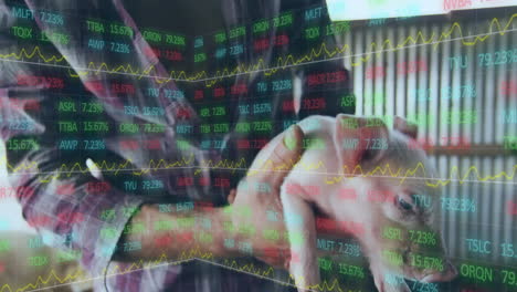 Stock market data animation over person holding piglet in farm setting