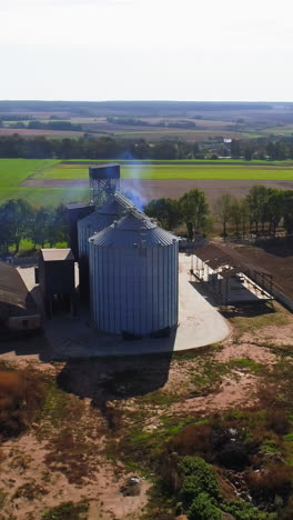 aerial view. metal grain elevator in agricultural zone. grain warehouse vertical video