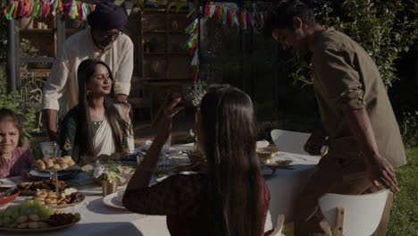 indian family enjoying a festive outdoor meal