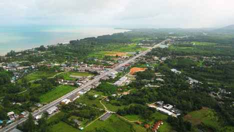 Khao-Lak-longest-National-Highway-4-runs-along-the-coast,-Thailand,-Slow-motion-Drone-shot