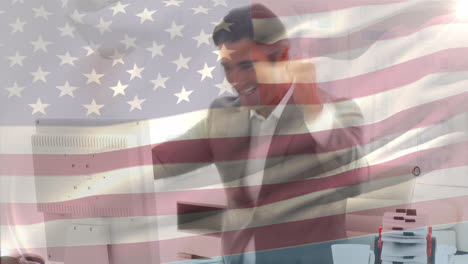 waving american flag against caucasian senior businessman celebrating at office