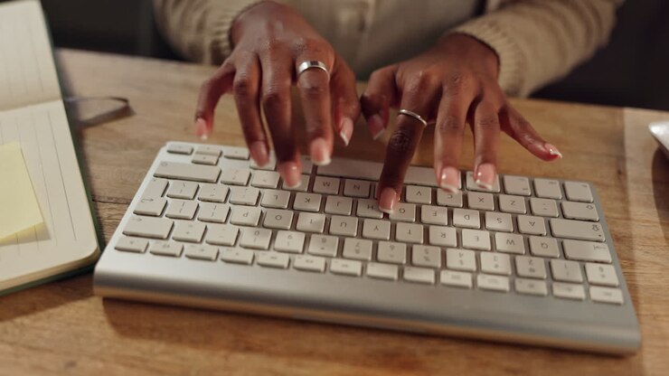 Woman typing on a keyboard