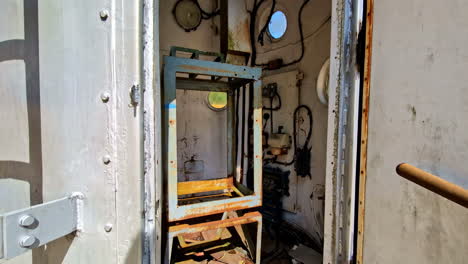 exploring the interior of an abandoned, rusted metal structure