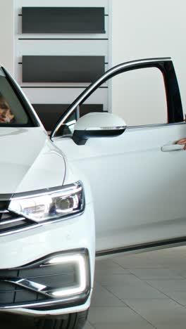 woman looking at a new car in a showroom