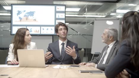 Thoughtful-business-team-communicating-in-conference-room