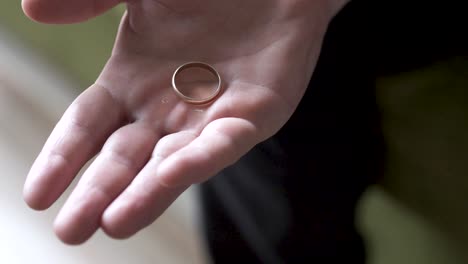 close-up-on-hand-make-fist-and-open-with-wedding-ring-fall-out-close-up