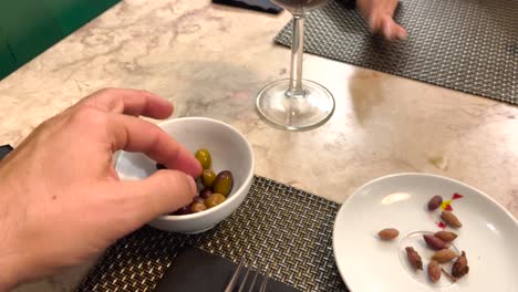 relaxed man enjoys typical olives soaked in olive oil