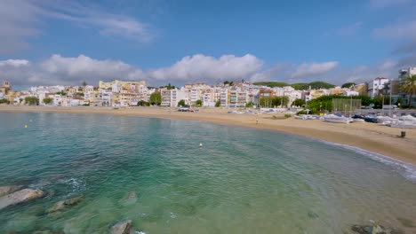 Platja-de-les-Barques-sea-field-Maresme-Barcelona-Mediterranean-coast-plane-close-to-turquoise-blue-transparent-water-beach-without-people