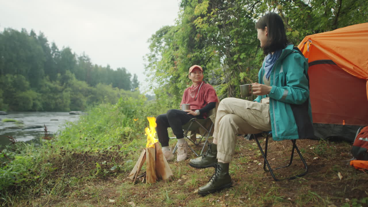 Asian Female Tourists Drinking Tea at Campsite