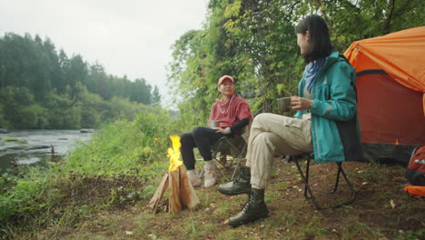 asian female tourists drinking tea at campsite