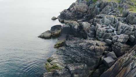 flying along the coastline of clogherhead with the calm ocean on a sunny day, ireland