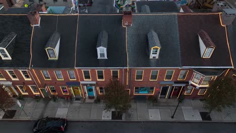 row houses in american city decorated with led christmas lights