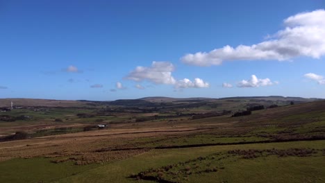 Aerial-shot-of-a-field-in-Broughshane,-County-Antrim-in-Northern-Ireland-on-a-sunny-day