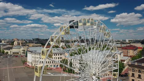 ferris wheel overlooking a city square on a sunny day