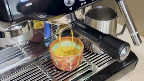 espresso machine brewing coffee into a cup, showcasing rich crema and steady flow, captured in a well-lit kitchen setting