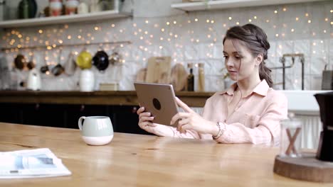 woman using tablet in kitchen