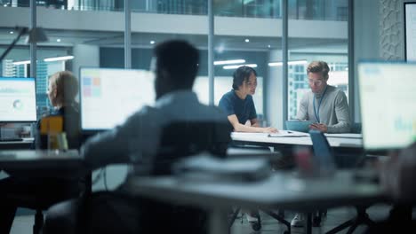 diverse team of managers working and having discussions in modern big city office. colleagues work on new business opportunities, ceo having meeting with employee, talking about investing in future.