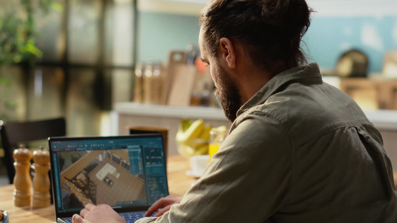 Interior designer working on architectural CAD software on laptop