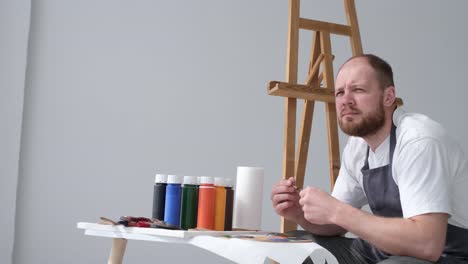 the artist prepares the paints for writing the nartina an artist works on an abstract oil painting - the artist prepares the paints for writing the nartina. an artist works on an abstract oil painting in a workshop. the concept of painting a picture