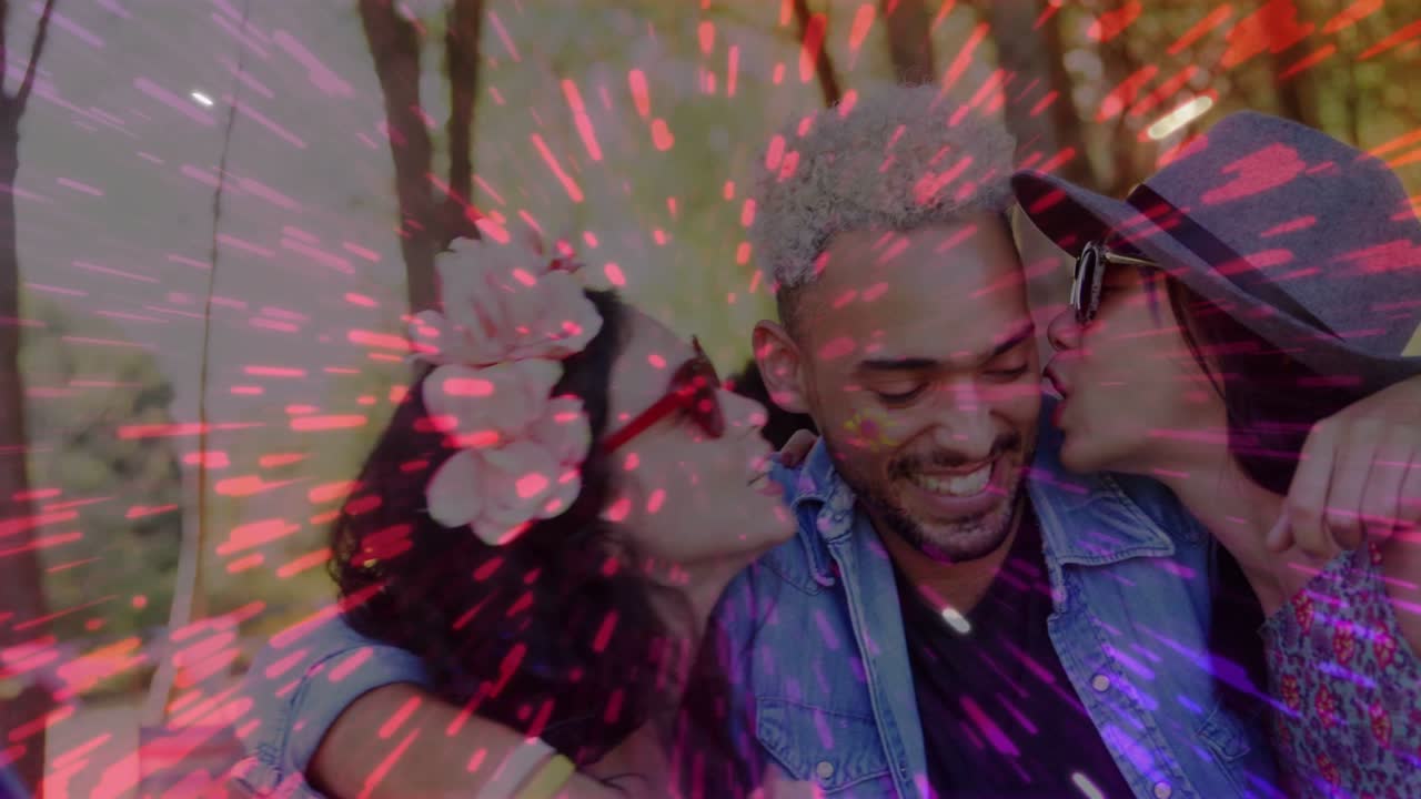 Man in denim jacket getting kissed, sparking laughing hug, pink overlay pulsing over trio for ads